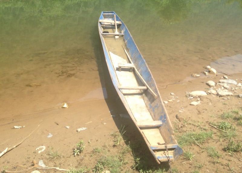 Old boat filled with water in Vang Vieng Laos