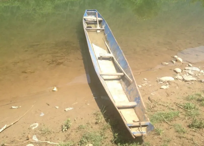 Old boat filled with water in Vang Vieng Laos