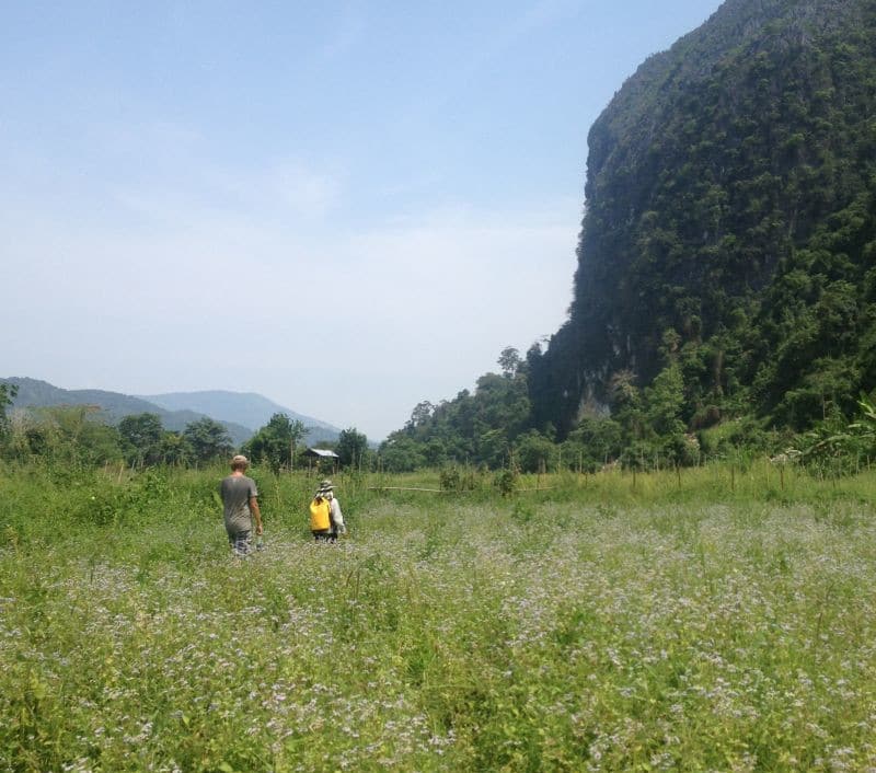 Hiking through tall grass in Vang Vieng