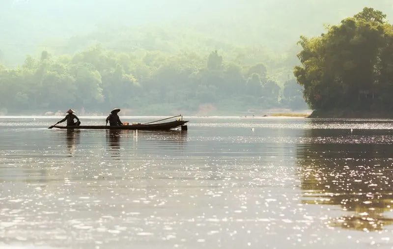 Men in boat on Mekong in Laos
